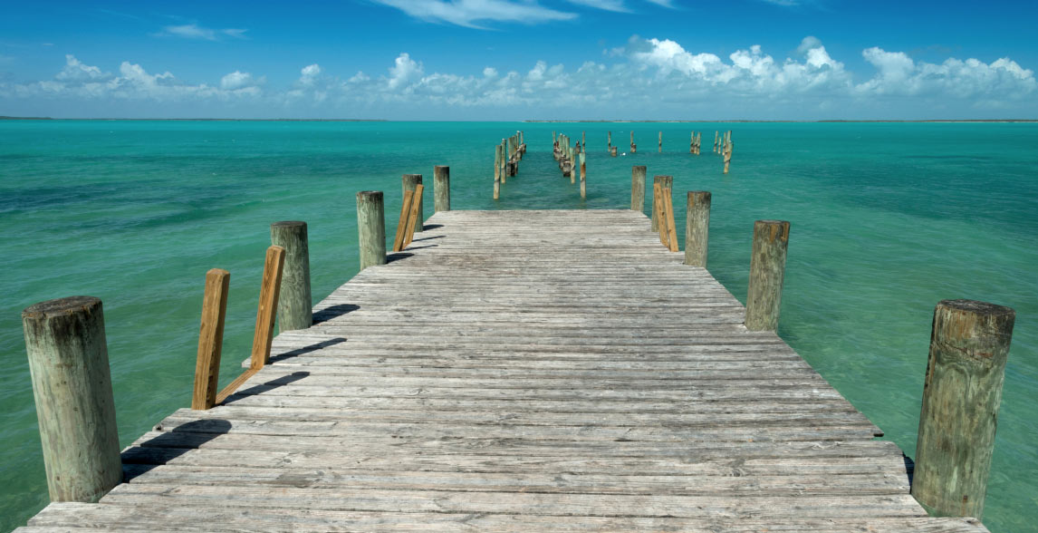 Pier extending out to the calm ocean.