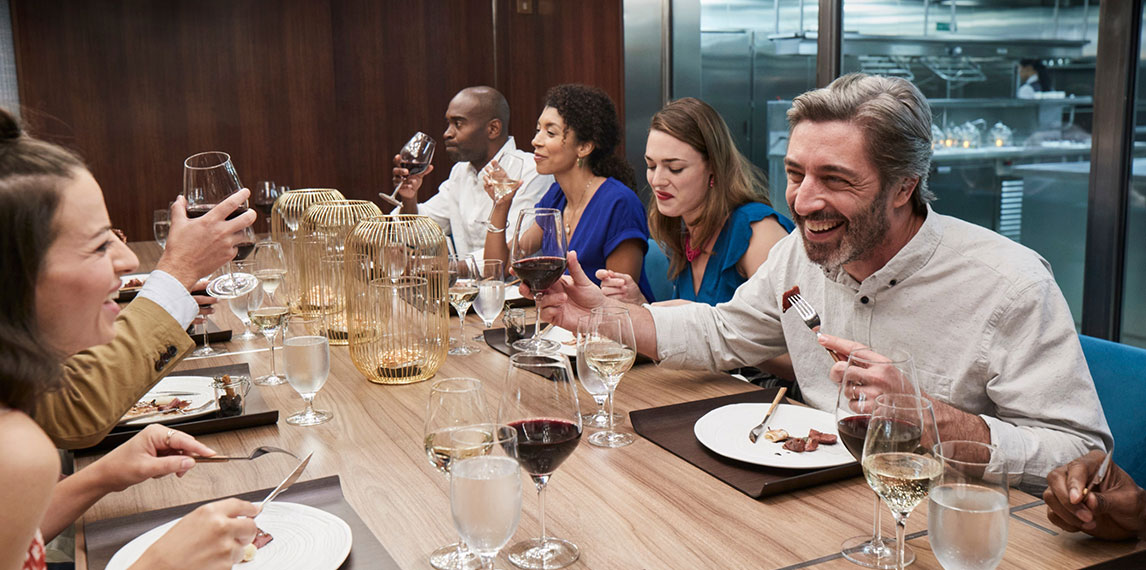 Group at table enjoying company and food.