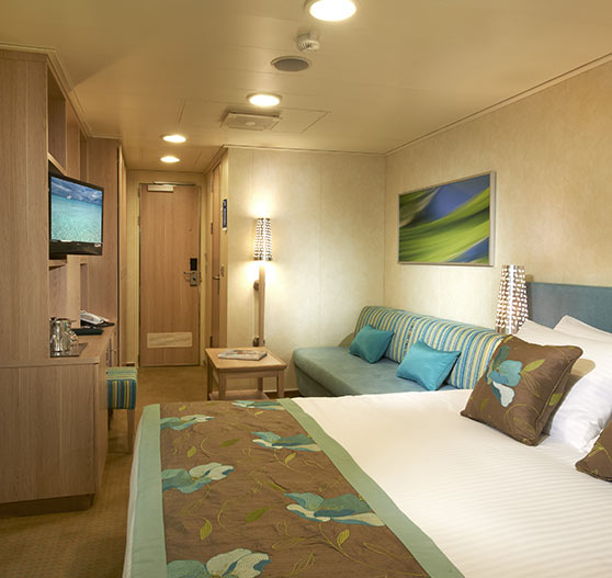 Interior of a balcony view stateroom on Carnival Breeze.