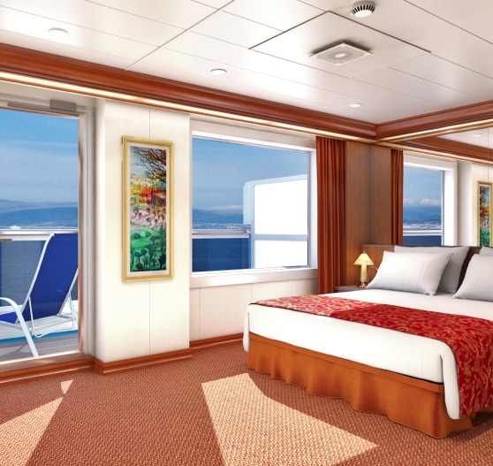 Interior of junior suite stateroom on Carnival Conquest.