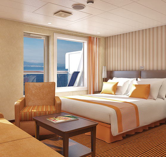 Interior of junior suite stateroom on Carnival Conquest.